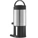 A stainless steel Grindmaster coffee shuttle with a black and silver stand.