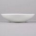 A white Reserve by Libbey Royal Rideau coupe bowl on a gray surface.