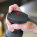 A hand holding a black Sammic medium-duty immersion blender with a red button.