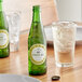 A green Boylan Diet Ginger Ale bottle next to a glass of ice and a bottle cap.