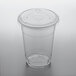 A clear Choice PET plastic cup with a flat lid on a table.