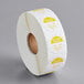 A roll of white paper with white and yellow labels that say "Tuesday" in yellow.