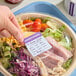 A roll of removable allergen warning labels designed to identify the presence of common allergens in food items.