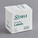 A white box of Noble Products removable blank labels with green text.