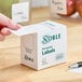 A box of Noble 2" x 2" permanent blank labels containing 500 labels per roll.