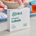 A box of Noble 1" x 2" permanent hospital labels containing 500 labels per roll.