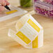 A roll of yellow dissolvable day of the week labels marked for Tuesday, used for food storage and organization.