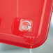 A red plastic container with a Noble Products Wednesday dissolvable day of the week clock label on it.