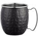 An Acopa Alchemy black metal Moscow Mule mug with a hammered design and metal handle.