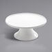 An American Metalcraft Prestige white porcelain cake stand with a round base and plate.