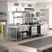 A Chef's Counter serving line package with stainless steel appliances and work tables.