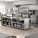 A Chef's Counter serving line with stainless steel work tables and shelves.