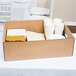 A white corrugated cardboard box full of Choice catering trays with a lid on top.