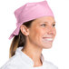 A woman wearing a light pink chef neckerchief.
