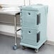 A slate blue Cambro Ultra Camcart food pan carrier on wheels.