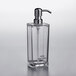 A clear plastic square hand sanitizer dispenser with a stainless steel pump and tube.