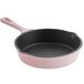 A pink enameled cast iron skillet with a handle.