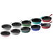 A row of Valor merlot enameled mini cast iron skillets in blue, green, and black.
