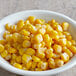 A bowl of Regal whole kernel sweet corn on a table.