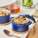 Two Valor Galaxy Blue enameled cast iron pots with food in them.
