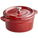 A Valor cranberry enameled cast iron pot with a lid and handle.
