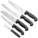 A group of Choice Essential knives with black handles on a counter.
