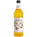 A bottle of Monin passion fruit syrup on a white background.
