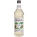 A bottle of Monin Premium Coconut Flavoring Syrup on a white background.