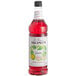 A close up of a Monin bottle of red guava syrup.