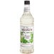 A white Monin bottle of Monin Premium Frosted Mint Flavoring Syrup with a label.