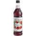 A bottle of Monin Pomegranate syrup with a label.