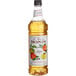 A Monin 1 liter bottle of apple fruit syrup.