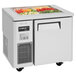 A white Turbo Air refrigerated buffet display table with food inside.