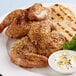 A plate of grilled chicken with Lawry's Garlic, Rosemary, and Lemon Rub and pita served with yogurt sauce.
