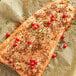 A piece of cooked salmon with McCormick Harissa Seasoning and red berries on top.