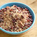 A bowl of Zatarain's red beans and rice on a table.