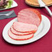 A Tuxton Alaska oval china platter with sliced ham