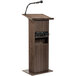 A wooden Oklahoma Sound lectern with a microphone.