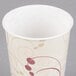 A Solo wax treated paper cold cup with a swirl design on it.