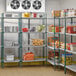 A storage room with Regency green wire shelving filled with food.