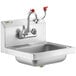 A stainless steel Regency wall mounted hand sink with red faucet handles.