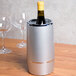 An American Metalcraft silver acrylic wine cooler with a bottle of wine inside.