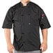A man wearing a black Uncommon Chef Delray Pro Vent chef coat with mesh back.