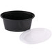 A black plastic oval souffle container with a clear plastic lid.