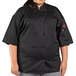 A woman wearing a Uncommon Chef black short sleeve chef coat.