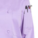 A close-up of a lilac Uncommon Chef long sleeve chef coat with a mesh back.