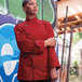 A woman in a red Uncommon Chef long sleeve chef coat.