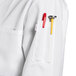 A close up of a Uncommon Chef white long sleeve chef coat pocket.