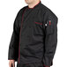 A man wearing a black Uncommon Chef coat with red trims.