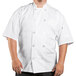 A man wearing a white Uncommon Chef Delray Pro Vent short sleeve chef coat with a mesh back.
